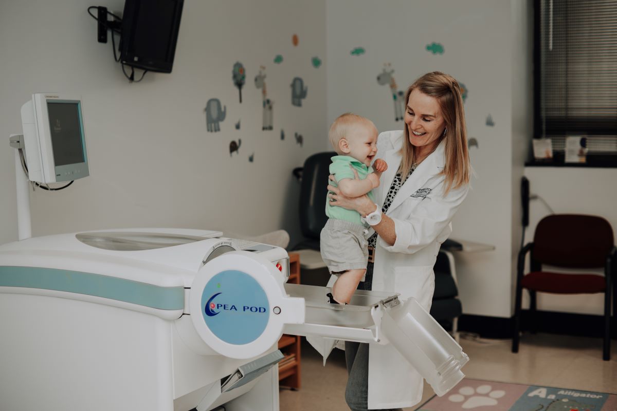 Dr. Leanne Redman with baby in medical clinic