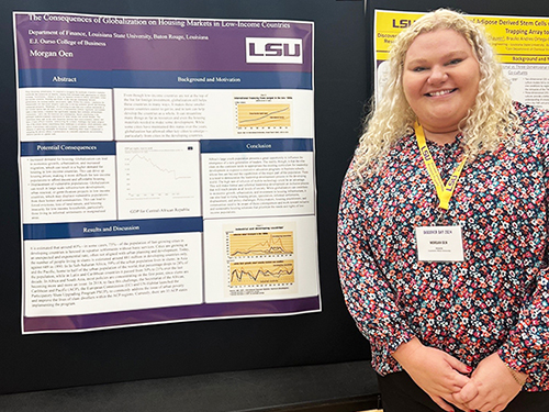 Morgan Oen stands by a poster display at LSU Discover Day.