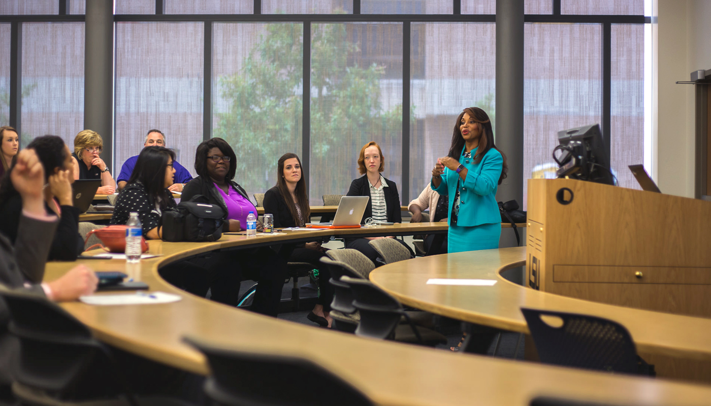 Female professor lectures class. 