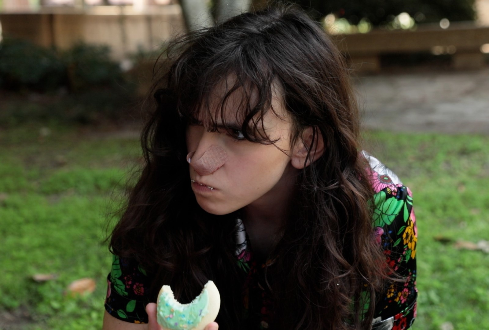 Person eating a cookie outside